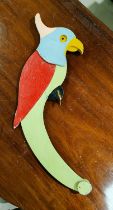 A vintage wooden parrot that balances and perches