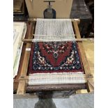 A carpet loom with a part completed rug. 29' high