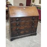 A George III mahogany bureau, the sloping fall over four long drawers, on bracket feet. 38' wide.