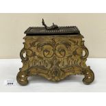 A 19th century gilt metal rococo revival casket, the lid with dolphin finial. Probably French. 9'