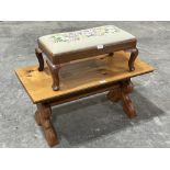 A pine low table on trestle support and a walnut footstool with woolwork top