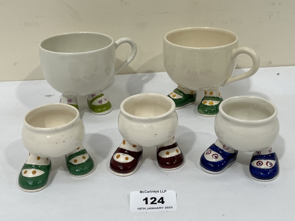Carlton Ware. A pair of 'Walk Ware' tea cups and three eggcups