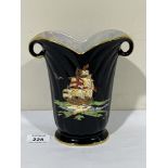 A Crown Devon Fieldings lustre vase, gilded and painted with a galleon on a black glaze, signed D.