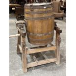 An E5 size coopered butter churn on stand by Llewellin & Son. Bears trade label for Rickards,