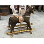 A Mamas & Papas rocking horse on trestle stand. 40' high