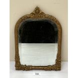 A 19th century gilt metal framed mirror with arched bevelled plate. 12½' high