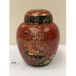 A Carlton Ware jar and cover, gilded and painted with oriental scenes. 7½' high