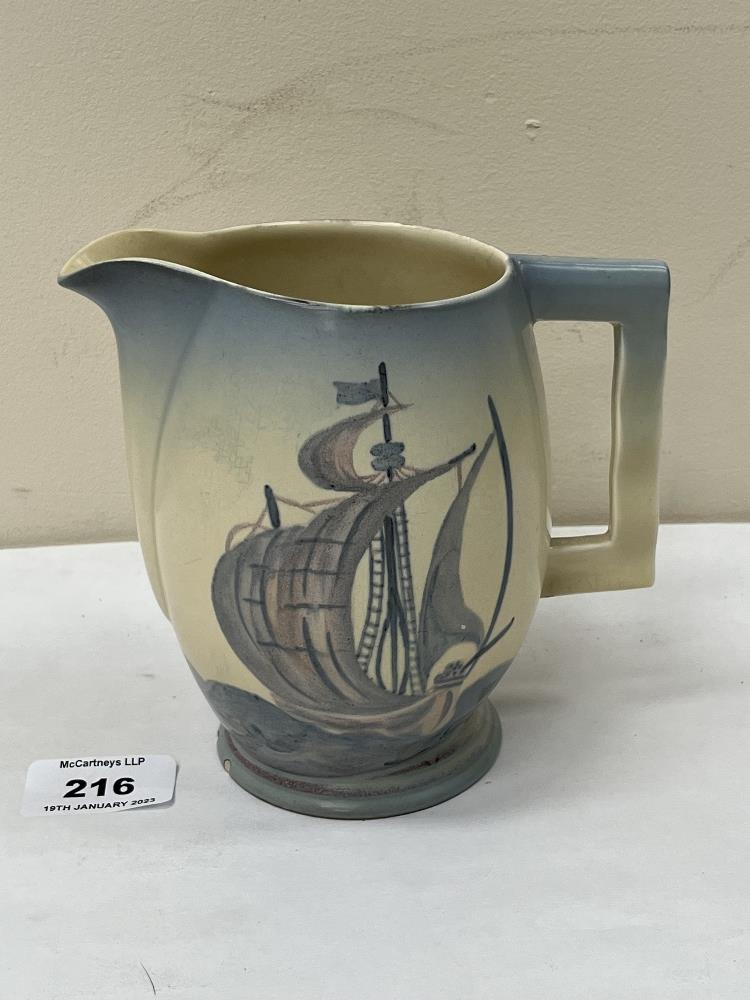 An Art-Deco Carlton Ware jug, painted with two sailing ships on a rolling sea. 5½' high. Two chips