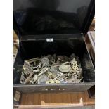 A tin box of door furniture, handles etc.