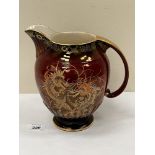 A Crown Devon Fieldings lustre jug, gilded and painted with Chinese dragons on a rouge ground. 8½'