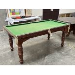 A quarter size E.J. Riley mahogany snooker table with slate bed on turned legs. To include a