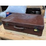 A vintage leather suitcase. 28' wide