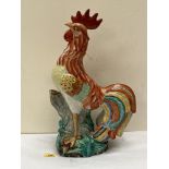 A majolica model of a cockerel, brightly decorated in coloured enamels. 19½' high