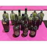 A collection of fourteen 19th century green glass ale and gin bottles