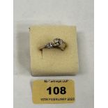 An 18ct two stone diamond crossover ring. 2g gross. Size K; together with another solitaire ring