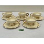 A set of five Art-Deco Robj Paris cups and saucers banded in gilt