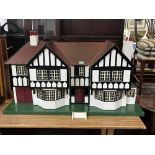 A Tri-Ang mock Tudor two bay doll's house with integral garage. c.1935. Later painted and wired