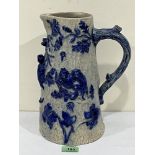 A late 19th century glazed stoneware jug, moulded in relief with monkeys and foliage. 11½' high