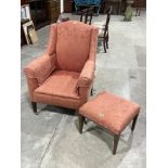 An Edward VII upholstered wing armchair with footstool