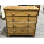 A Victorian pine chest of drawers with mother-of-pearl escutcheons on turned feet. 39½' wide