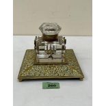 A Victorian cast brass inkstand with cut glass well. 6' wide. Corner chips to well