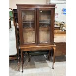 A mahogany glazed bookcase and a side table