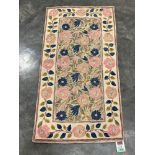 A Kashmiri stitched wool chain rug. 1.1m x 0.58m