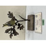 An Albany China Greenfinch, the bird raised on an oak branch and marble base. No. 386/500. Boxed