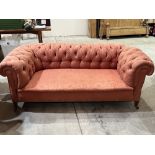 An Edward VII chesterfield sofa with deep buttoned back and arms, on square tapered feet. 72'w