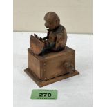 A Japanese Meiji period boxwood kobe automation toy, modelled as a figure eating a melon, with