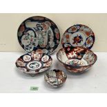 Five items of Japanese Imari ceramics. The larger dish with stapled repairs