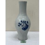 A Chinese blue and white reeded vase, decorated in three reserves with birds and prunus. Kangxi mark