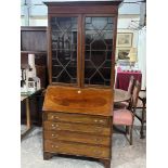 An Edward VII mahogany line inlaid and banded bureau bookcase enclosed by a pair of astragal