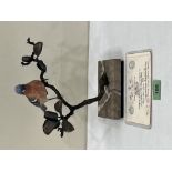 An Albany China Chaffinch, the bird raised on a bronzed metal leafy branch and marble base. No.