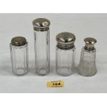 Four silver topped dressing table jars. 5¼' high and smaller