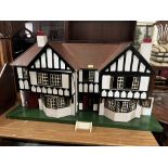 A Tri-Ang mock Tudor two bay doll's house with integral garage. c.1935. Later painted and wired