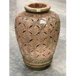 A terracotta garden vase with pierced geometric decoration. 31' high