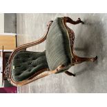An early Victorian walnut and upholstered lady's salon chair with carved downswept frame and