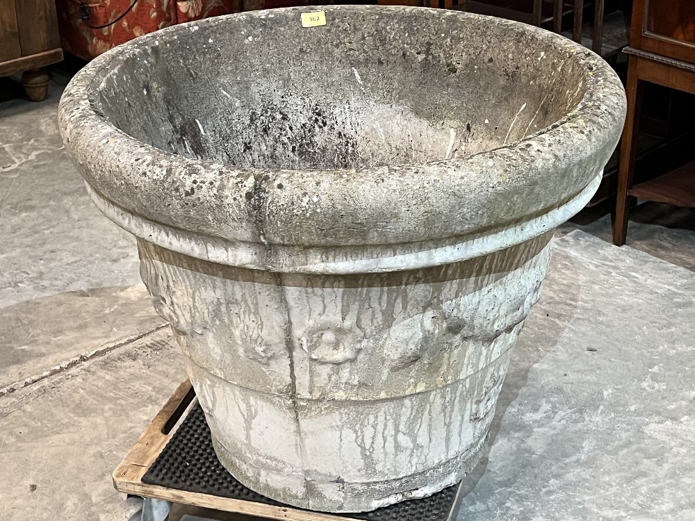 A garden urn with moulded decoration. 30' diam x 24' high