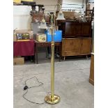 A brass three light lamp standard with frosted glass bell shades. 66' high