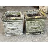 A pair of square garden urns with relief moulded decoration. 16'w x 15½'h