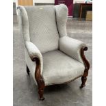 A Victorian walnut and upholstered wing armchair