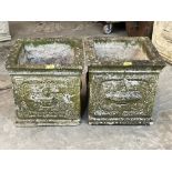 A pair of square garden urns with relief moulded decoration. 16'w x 15½'h