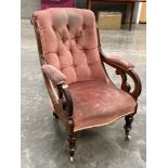 A Victorian walnut and upholstered armchair with deep buttoned back on inverted baluster turned