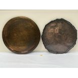 An Arts and Crafts style copper tray with shaped rim, 21½' diam; together with an Islamic brass