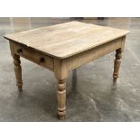 A Victorian pine kitchen table, the plank top over a frieze drawer on turned legs. 50' long x 39'