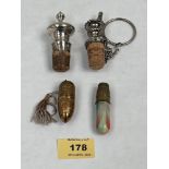 A silver bottle cork; a white metal example and two sewing cases