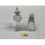 Two George V glass scent bottles with stoppers and silver collars. 5¾' high and smaller