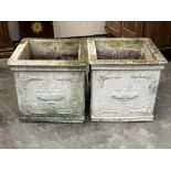 A pair of square garden urns with relief moulded decoration. 20'w x 19'h
