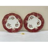 A pair of plates painted with summer flowers. 9' diam.